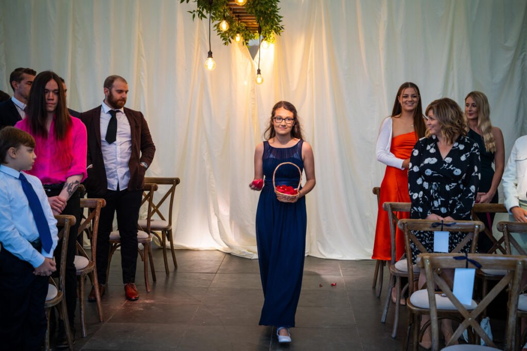 bridesmaid walking down the aisle at Trevenna Barns Cornwall