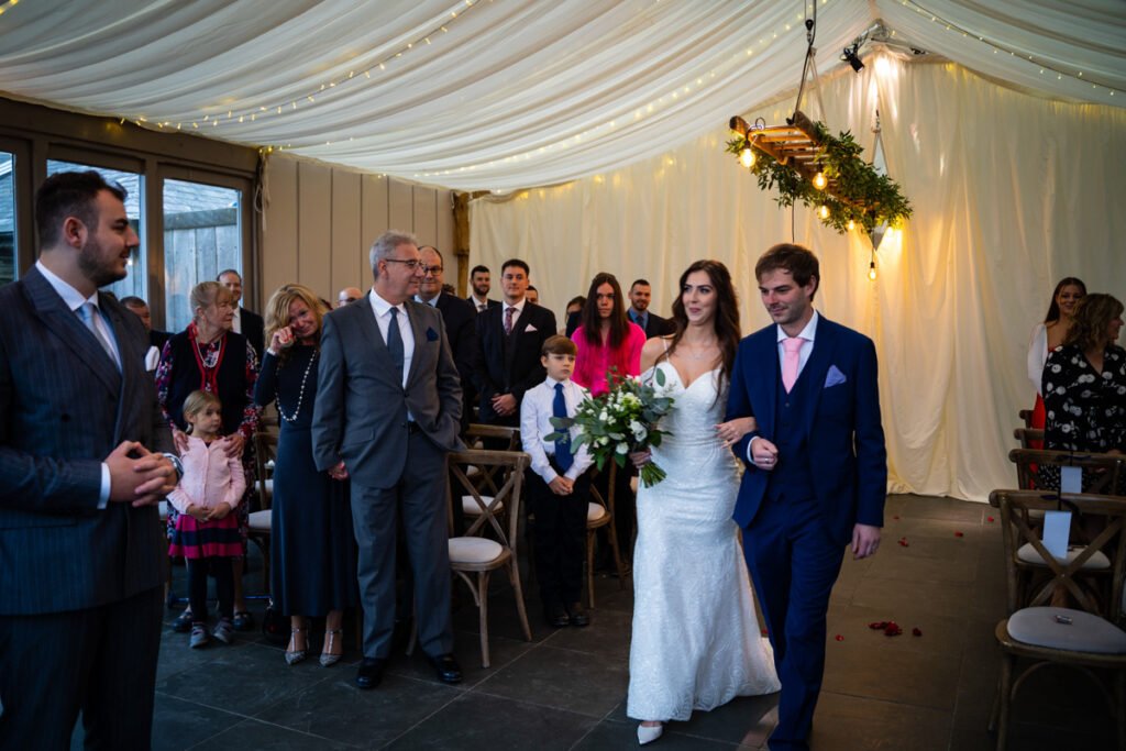 bride walking down the aisle at Trevenna Barns Cornwall