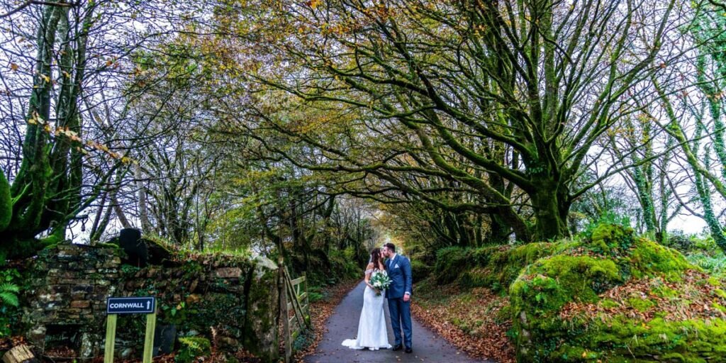 Bride and groom autumn trees at Trevenna Barns Cornwall