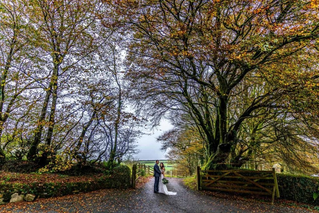 Bride and groom autumn trees at Trevenna Barns Cornwall HDR