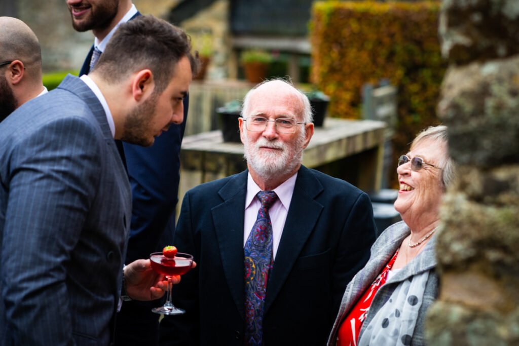 wedding guests talking to the groom at Trevenna Barns Cornwall