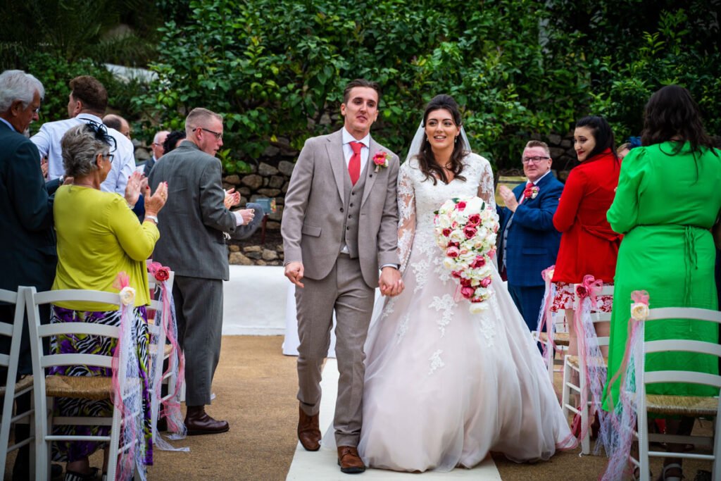 Bride and groom exiting the wedding ceremony at the Eden Project Cornwall