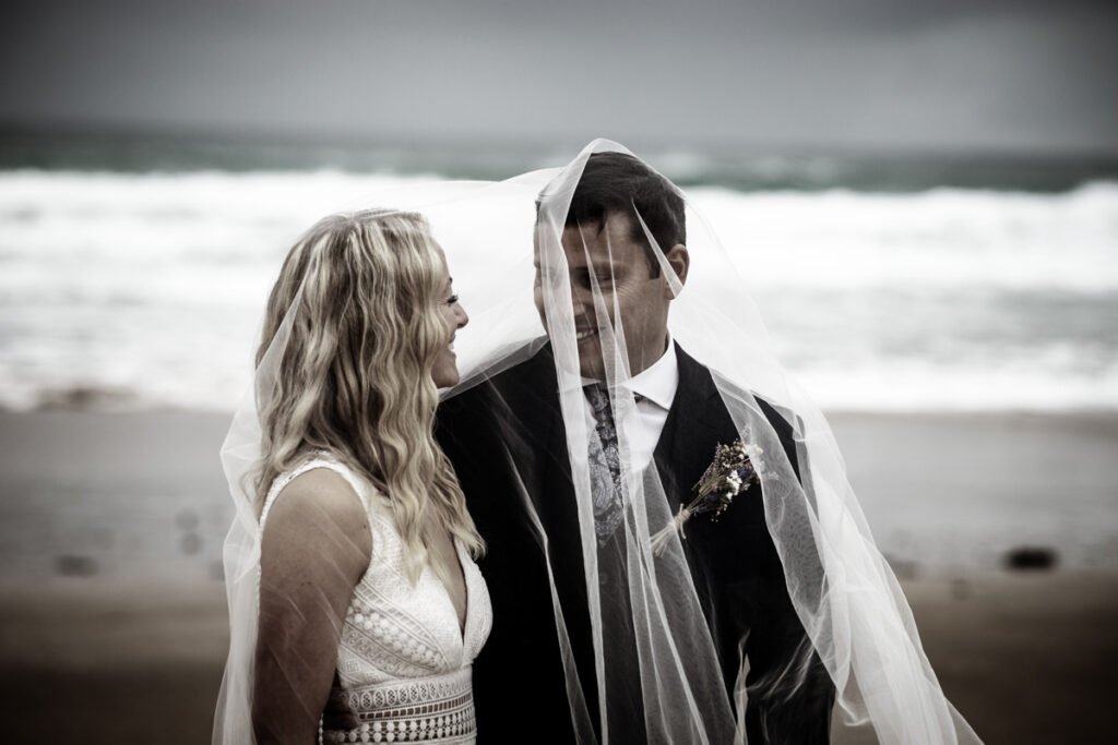 bride and groom on the beach B&W