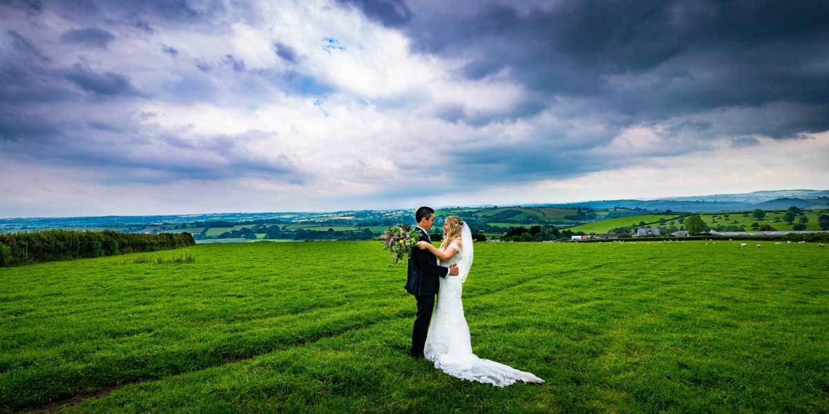bride and groom portrait in the fields in cornwall