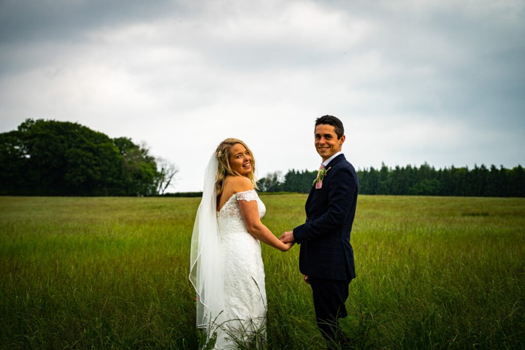 bride and groom portrait in the fields in cornwall