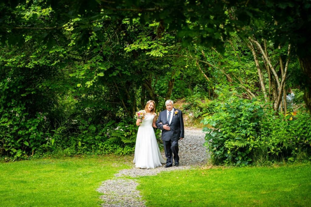 bride and father arriving at cornish tipis in cornwall