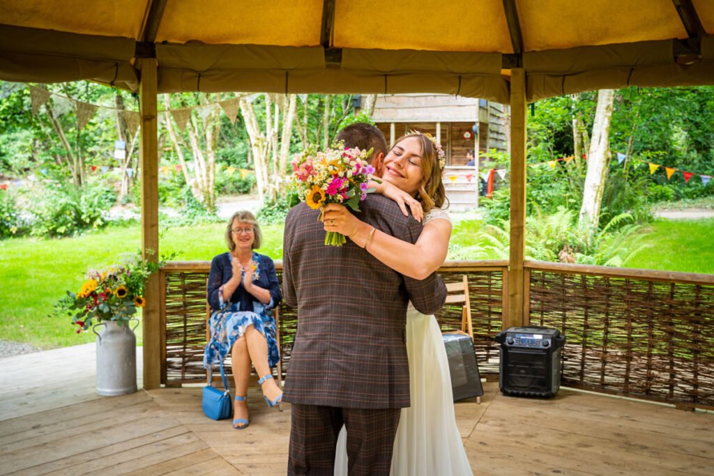 bride and groom embrace at cornish tipis in cornwall