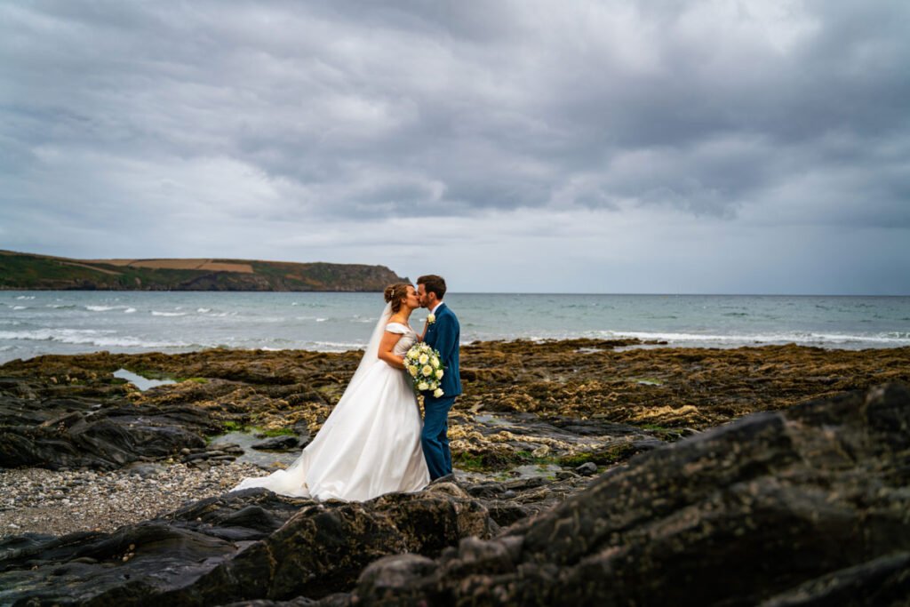 bride and groom on the beach in cornwall