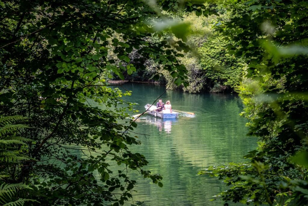 bride and groom rowing boat at cornish tipis in cornwall