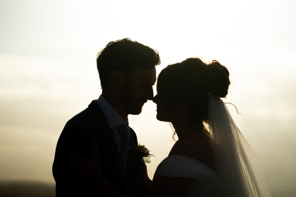 bride and groom silhouette shot in cornwall