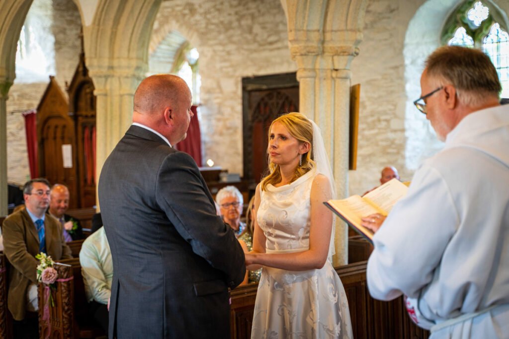bride and groom saying vows at a wedding in cornwall