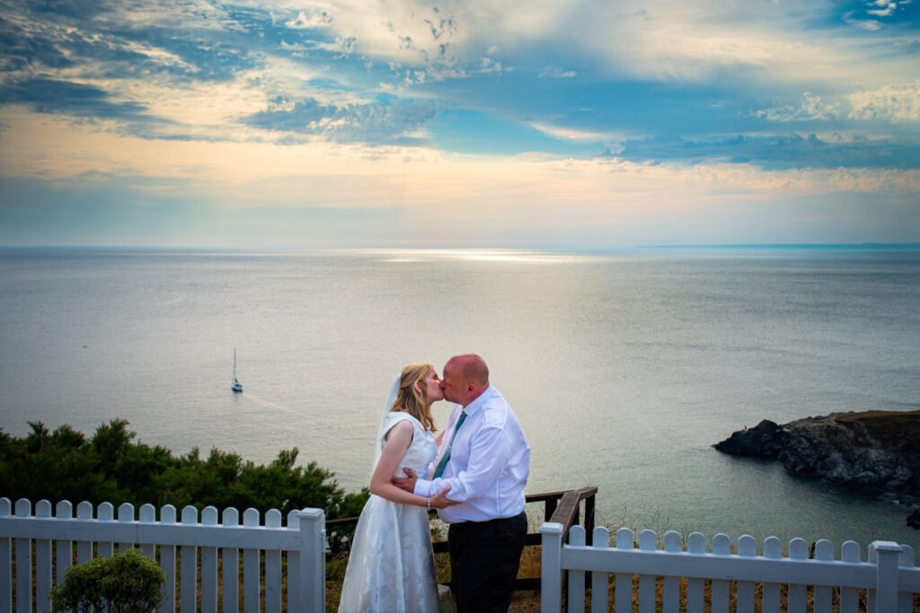 bride and groom kissing sunset shot in cornwall