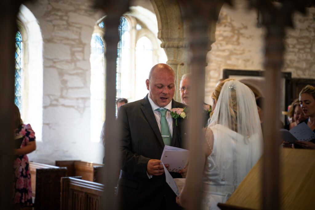 candid groom singing at a wedding ceremony in cornwall