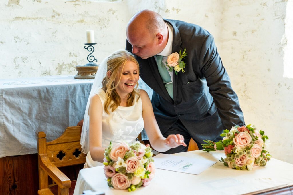 Bride and groom signing the register