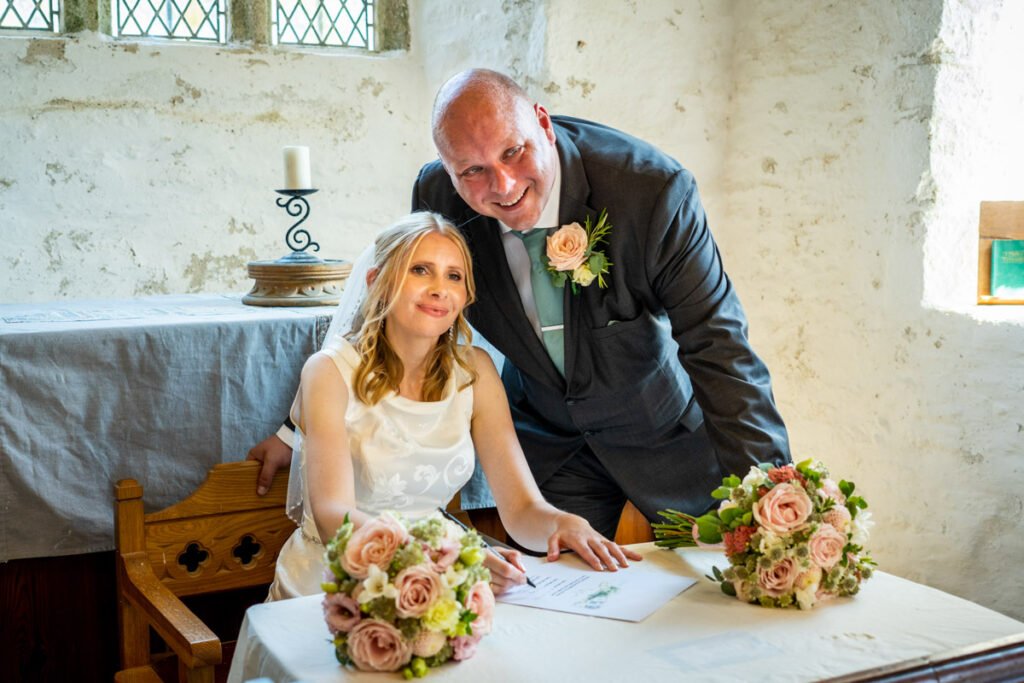 Bride and groom signing the register