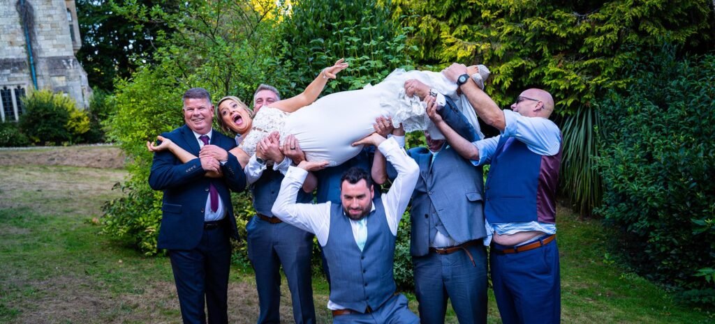 bride being carried by the grooms men
