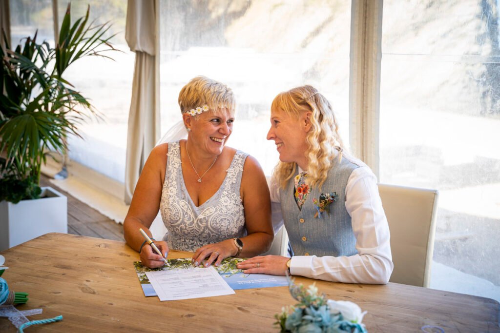 newquay same sex wedding bride and bride signing