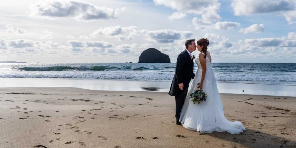 Bride and groom at Trebarwith starnd beach in cornwall