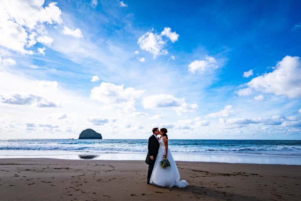 Bride and groom at Trebarwith starnd beach in cornwall