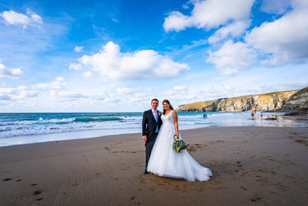 Bride and groom at Trebarwith starnd beach in cornwall