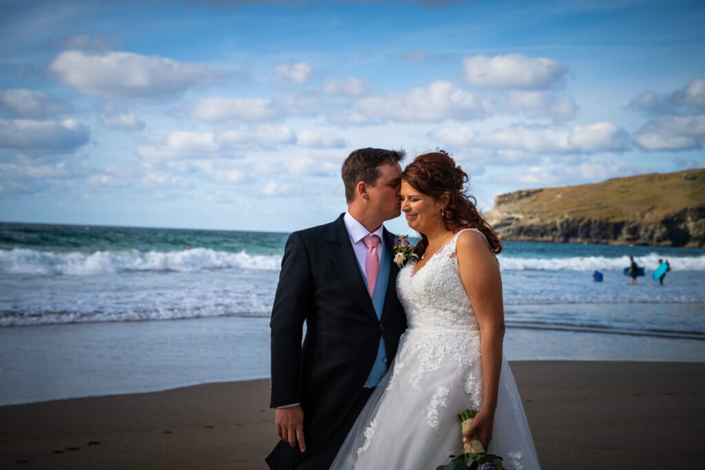 Bride and groom at Trebarwith starnd beach in cornwall