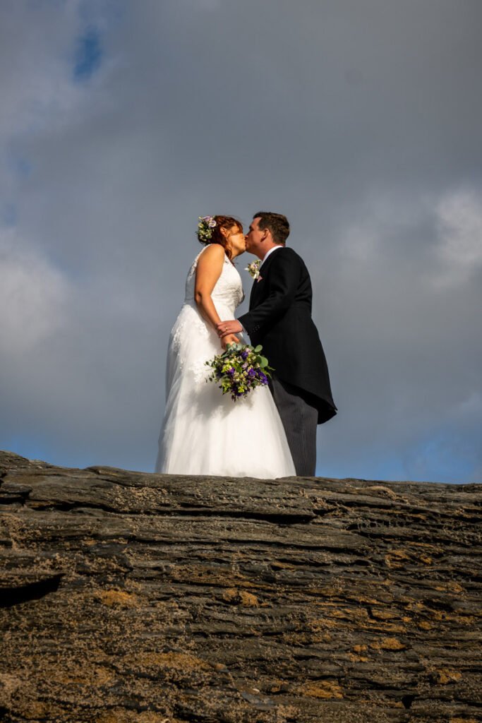 bride and groom kissing shot from below