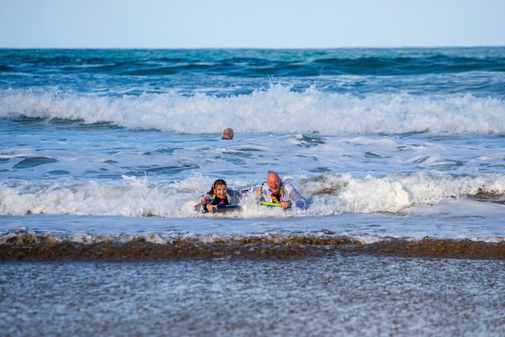 bride and groom surfing in cornwall