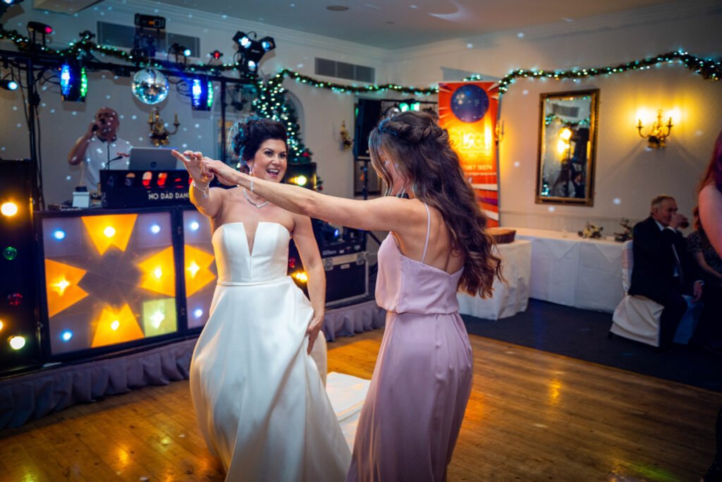 Bride and Bridesmaid dancing image