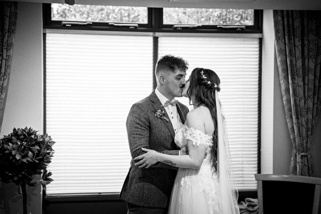 Bride and Groom kissing wedding photograph in Cornwall