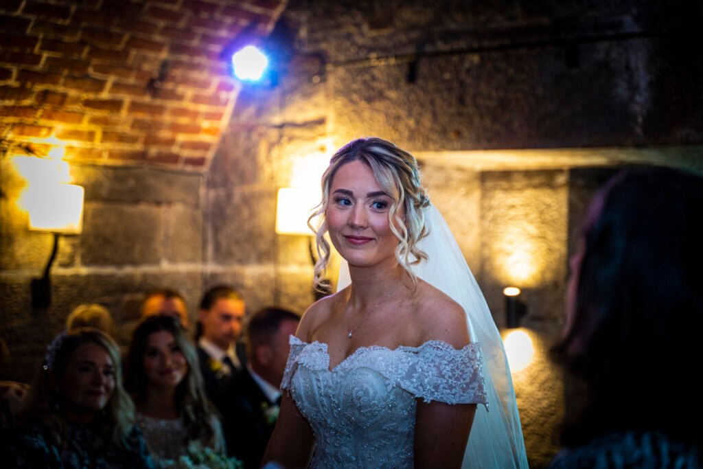 bride exchanging vows at the wedding ceremony at Polhawn Fort cornwall wedding venue