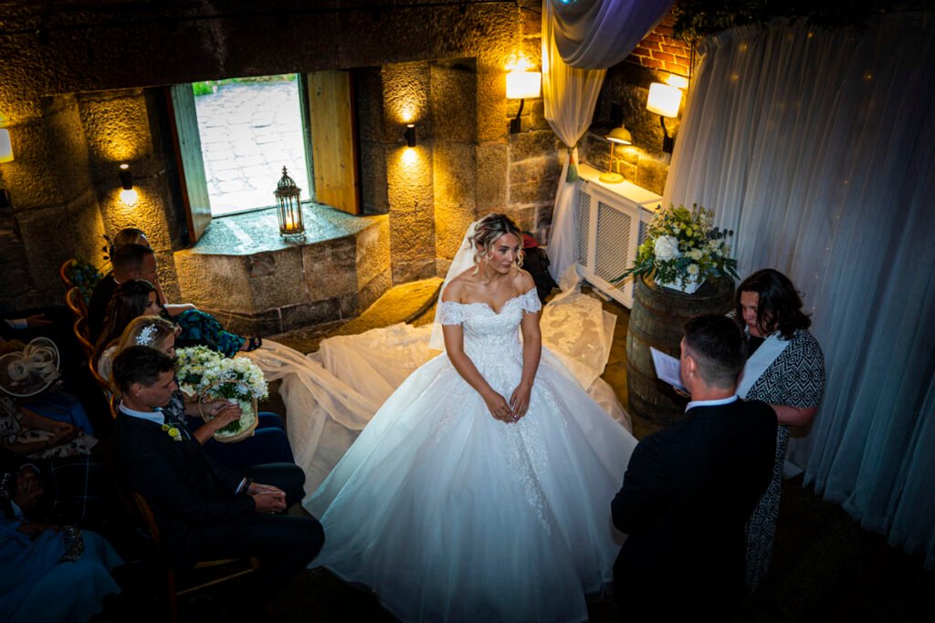 bride and groom exchanging vows at the wedding ceremony at Polhawn Fort cornwall wedding venue overhead shot