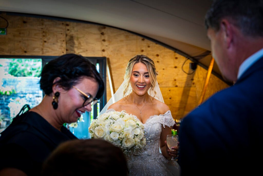 bride with her bouquet after the reception at Polhawn Fort cornwall wedding venue