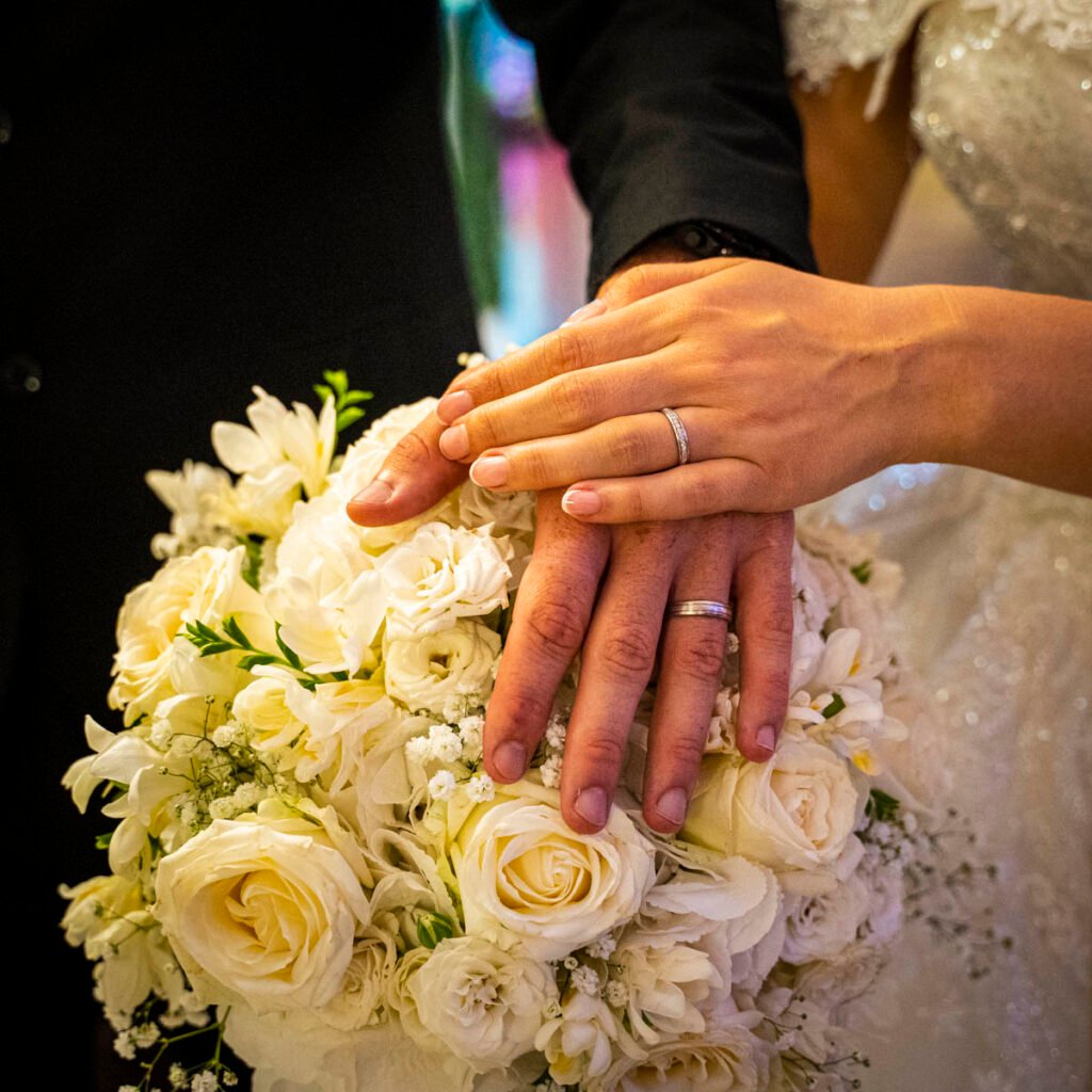 wedding rings hands close up on the brides bouquet
