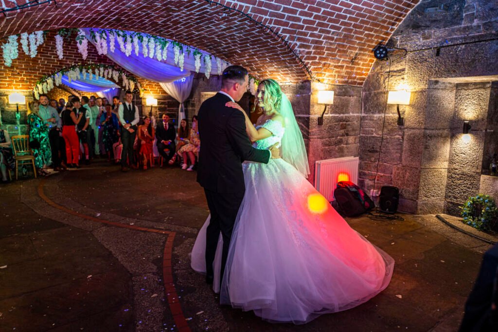 bride and groom dancing together at Polhawn Fort cornwall wedding venue