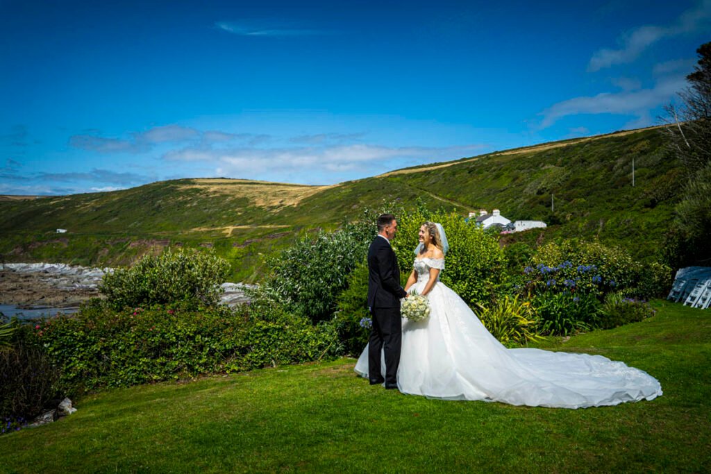bride and groom pose in the garden at Polhawn Fort cornwall