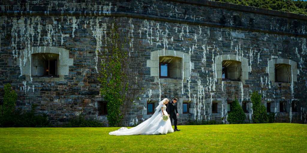 bride and groom walking in the garden at Polhawn Fort cornwall