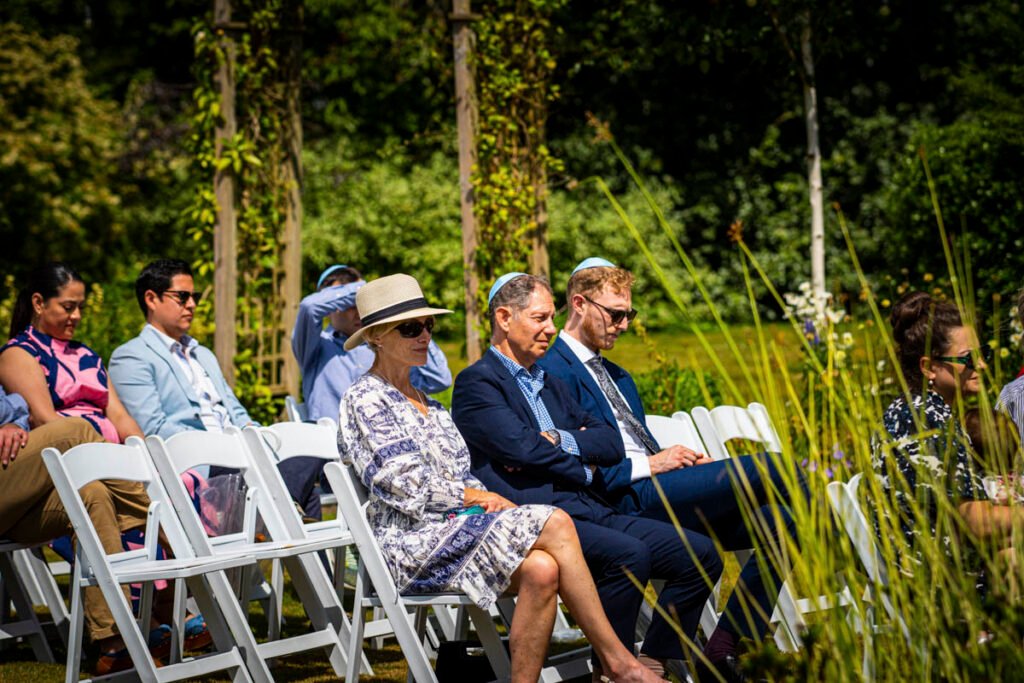 wedding guests sat waiting for the wedding ceremony to begin