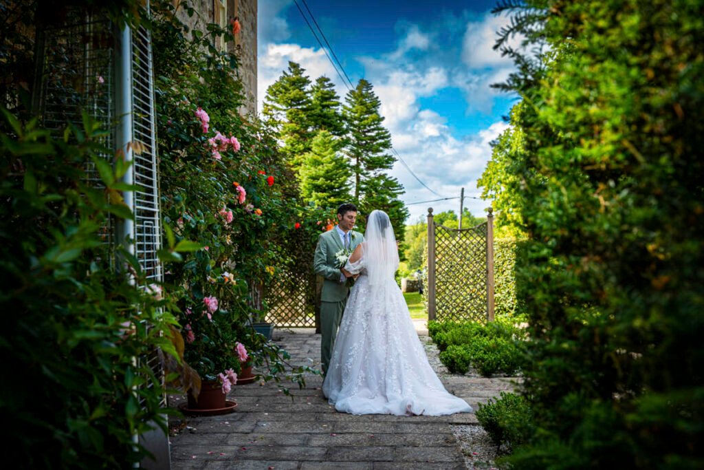 bride and groom embrace in the garden