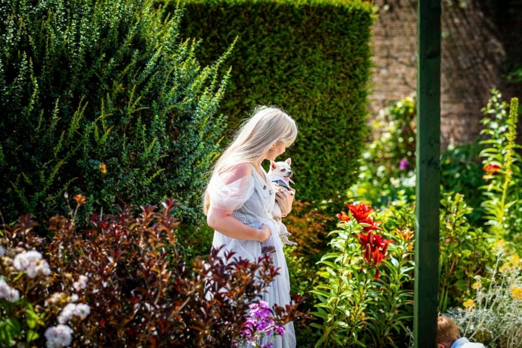 casual bridemaid portrait with dog in the gardens