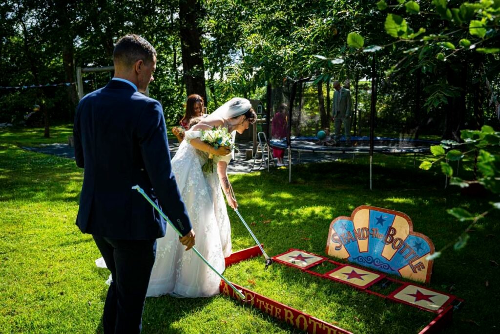 bride and guest playing outdoor wedding games