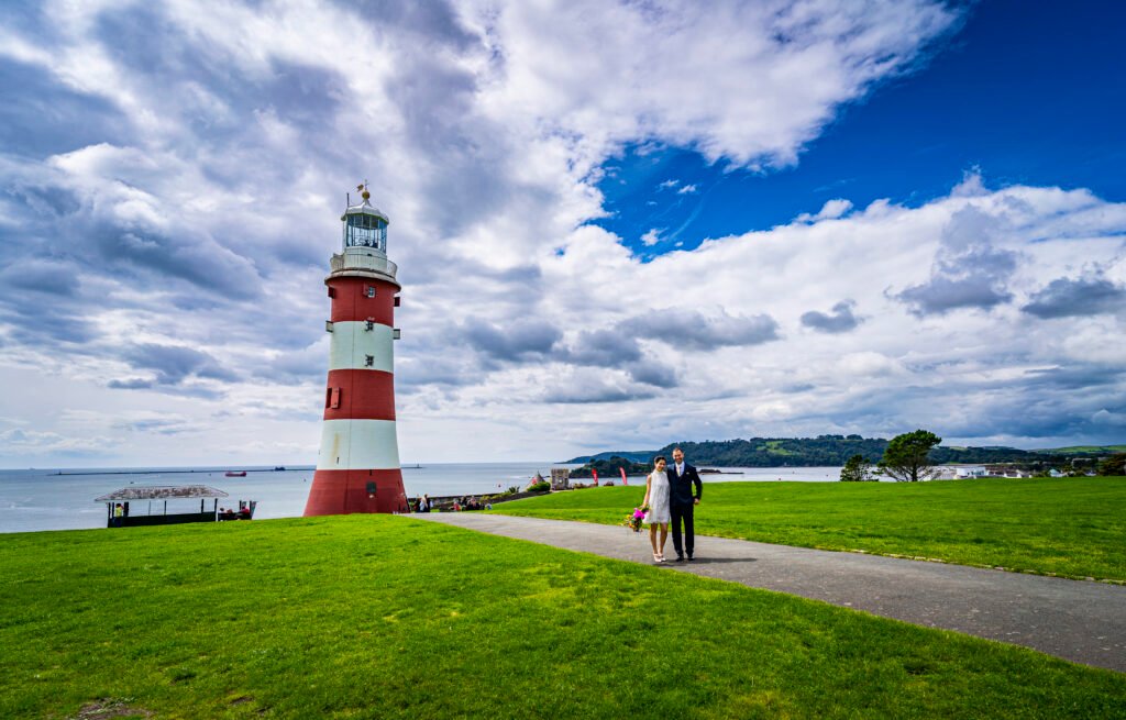 Bride and groom in front of Smeaton's Tower on plymouth Sound