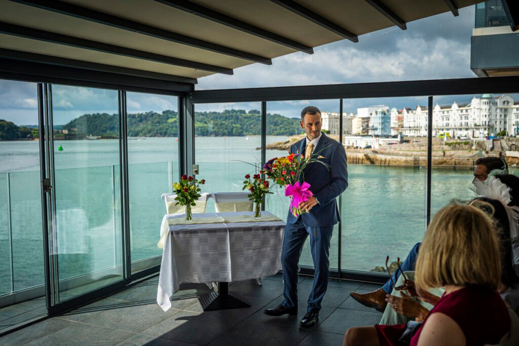 groom with the bouquet during the wedding ceremony