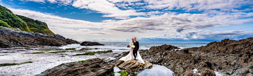 Bride and Groom on the beach at Polhawn Fort cornwall by cornwall wedding photographer