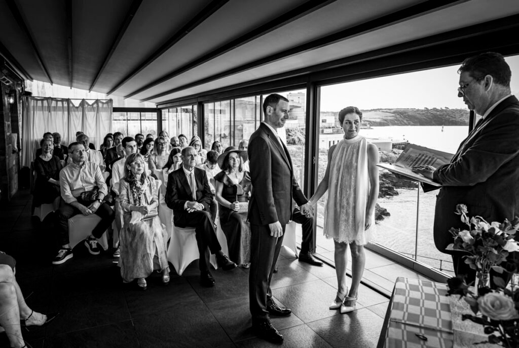 bride and groom exchanging vows during the wedding ceremony B&W