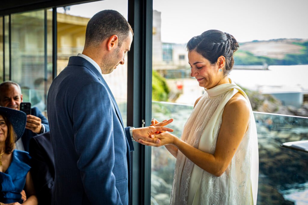 bride and groom exchanging rings during the wedding ceremony