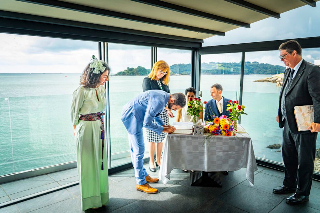 Bride and groom and witnesses signing the registe