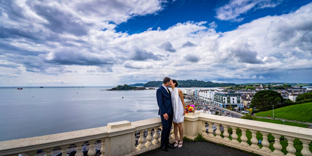 bride and groom kissing overlooking Plymouth Sound