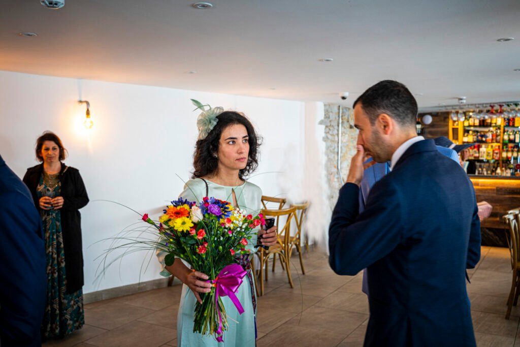 groom with sister and the wedding bouqyet