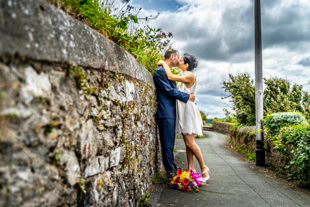 bride and groom kissing Plymouth Sound