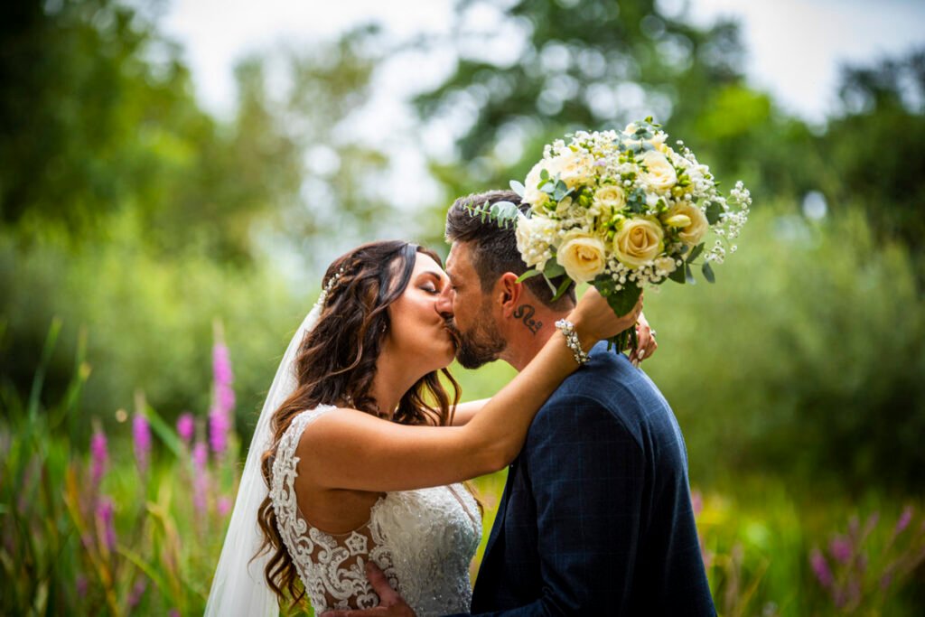 bride and groom kissing in the garden